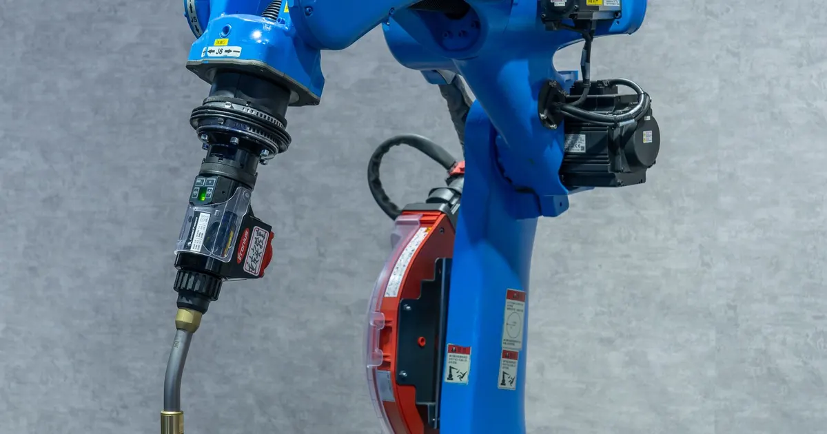 Six-axis industrial robot arm with a MIG welding torch mounted on its wrist, the equipment behind robotic welding of machine frame sub-assemblies